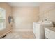 Spacious laundry room with tile flooring, built-in shelving, a utility sink, and washer and dryer at 3130 Crestmont Nw Way, Kennesaw, GA 30152