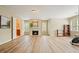 Open-concept living room with hardwood flooring, a cozy fireplace, and access to an adjacent bathroom at 3130 Crestmont Nw Way, Kennesaw, GA 30152