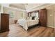 Spacious main bedroom features tray ceiling, wood floors, natural light, and built in cabinetry at 3130 Crestmont Nw Way, Kennesaw, GA 30152