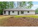 View of the home's backyard featuring a well-maintained lawn and exterior of the house at 40 Melton Way, Covington, GA 30016