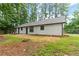 View of the home's spacious backyard, with mature trees and a lush, green lawn at 40 Melton Way, Covington, GA 30016