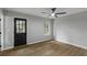 Bedroom with a ceiling fan, wood floors, a backyard-facing door and a large window at 40 Melton Way, Covington, GA 30016