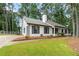 Charming single-story home featuring black shutters, white siding, and a well-manicured front lawn at 40 Melton Way, Covington, GA 30016