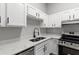 Bright kitchen featuring white cabinets, stainless steel appliances, and quartz countertops at 40 Melton Way, Covington, GA 30016