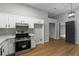 Updated kitchen with white cabinets, modern appliances, and adjacent living area at 40 Melton Way, Covington, GA 30016