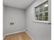 Laundry room featuring wood floors, grey walls and a window overlooking the backyard at 40 Melton Way, Covington, GA 30016