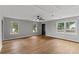 Bright living room featuring wood floors, grey walls and large windows overlooking the yard at 40 Melton Way, Covington, GA 30016
