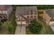 Aerial view of a two-story home with mature trees, lawn, and a two-car garage at 7601 Watson Cir, Locust Grove, GA 30248