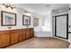 Bright bathroom featuring double vanities, corner tub, and glass-enclosed shower at 7601 Watson Cir, Locust Grove, GA 30248