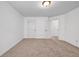 A cozy bedroom boasts neutral carpet, white walls, doors and trim, and a modern ceiling light at 7601 Watson Cir, Locust Grove, GA 30248