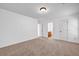 A cozy bedroom boasts neutral carpet, white walls, doors and trim, and a modern ceiling light at 7601 Watson Cir, Locust Grove, GA 30248