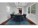 Bright dining room with wainscoting, coffered ceilings, chandelier, and hardwood floors at 7601 Watson Cir, Locust Grove, GA 30248