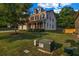 Two-story home with a two-car garage, landscaped front yard, and neutral siding at 7601 Watson Cir, Locust Grove, GA 30248