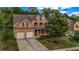 Beautiful two-story brick home with a two-car garage and a mature front yard at 7601 Watson Cir, Locust Grove, GA 30248