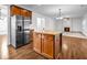 Open concept kitchen with a granite-topped island, stainless steel appliances, and hardwood flooring at 7601 Watson Cir, Locust Grove, GA 30248