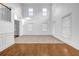 Bright living area with hardwood flooring, high ceilings, and ample natural light offers a spacious design at 7601 Watson Cir, Locust Grove, GA 30248