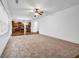 Bright living room with plush carpet, hardwood floors, and a kitchen view provides a modern living space at 7601 Watson Cir, Locust Grove, GA 30248