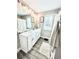 Bright bathroom featuring a dual sink vanity, neutral paint, and wood look flooring at , Covington, GA 30014