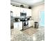 Bright kitchen with stainless steel appliances, white cabinetry, and a view of the backyard at , Covington, GA 30014