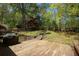 Wooden deck overlooking a spacious, green backyard with mature trees and wooden perimeter fence at 1252 Heritage Dr, Villa Rica, GA 30180