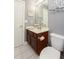 Cozy bathroom features wood vanity, white sink, and toilet at 1252 Heritage Dr, Villa Rica, GA 30180