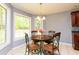 Sunlit kitchen nook with table set and a view of the beautiful outdoors at 1252 Heritage Dr, Villa Rica, GA 30180