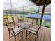 Charming outdoor deck featuring seating, perfect for enjoying the weather and overlooking tennis courts at 1252 Heritage Dr, Villa Rica, GA 30180