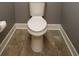 Bathroom with gray paint, and elongated toilet at 1252 Heritage Dr, Villa Rica, GA 30180
