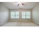 Spacious bedroom with wall-to-wall carpeting, two windows for natural light, and a ceiling fan at 1293 Liberty Nw Pkwy, Atlanta, GA 30318