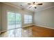 Bedroom featuring hardwood floors, natural light, and a sliding door to the wooden deck at 1293 Liberty Nw Pkwy, Atlanta, GA 30318