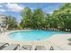 Community pool surrounded by lounge chairs and lush green trees at 1293 Liberty Nw Pkwy, Atlanta, GA 30318