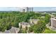View of buildings nestled in a lush, green area with buildings in the distance and blue skies above at 3108 Westchester Ne Rdg, Atlanta, GA 30329