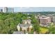 Aerial view featuring a lush tree canopy and a mix of residential and commercial buildings in the distance at 3108 Westchester Ne Rdg, Atlanta, GA 30329