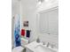 Bright bathroom with a clean white vanity, framed mirror and decorative shower curtain at 3108 Westchester Ne Rdg, Atlanta, GA 30329