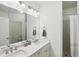 Elegant bathroom with dual sinks, framed mirrors, and a glass-enclosed shower at 3108 Westchester Ne Rdg, Atlanta, GA 30329
