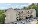 Tan building with a dark roof, balconies, visible parking, and lush trees surrounding the property at 3108 Westchester Ne Rdg, Atlanta, GA 30329