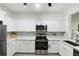 Open kitchen with stainless appliances, sleek white cabinets, and a modern design at 3108 Westchester Ne Rdg, Atlanta, GA 30329