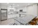 Modern kitchen with white cabinets, stainless steel appliances, granite countertops, and bar seating at 3108 Westchester Ne Rdg, Atlanta, GA 30329