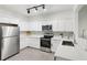 Bright kitchen features stainless steel appliances, white cabinets, and stylish tile backsplash at 3108 Westchester Ne Rdg, Atlanta, GA 30329