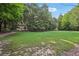Expansive green space surrounded by mature trees perfect for outdoor activities at 3108 Westchester Ne Rdg, Atlanta, GA 30329