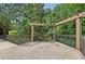 Brick patio with a wooden pergola overlooking a beautiful landscape with mature trees at 3108 Westchester Ne Rdg, Atlanta, GA 30329