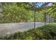 Community tennis court with surrounding trees and fence at 3108 Westchester Ne Rdg, Atlanta, GA 30329