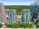 Stunning aerial view of luxury high-rise condos with a pool and beautiful green surroundings at 943 Peachtree Ne St # 2001, Atlanta, GA 30309