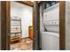 Compact laundry area, featuring stacked washer and dryer, and bathroom entry at 943 Peachtree Ne St # 2001, Atlanta, GA 30309