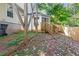 View of backyard with wooden fence, landscape, and a small wooden staircase up to the back of the house at 2140 Wildcat Cliffs Way, Lawrenceville, GA 30043