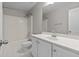 Bright bathroom with white vanity, sink, and tub-shower combination at 2140 Wildcat Cliffs Way, Lawrenceville, GA 30043