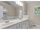 Well-lit bathroom with double sink vanity, large mirror, and separate shower at 2140 Wildcat Cliffs Way, Lawrenceville, GA 30043