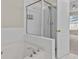 Bathroom featuring a tub and shower combination with a glass door at 2140 Wildcat Cliffs Way, Lawrenceville, GA 30043
