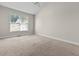 Neutral bedroom featuring a large window, carpet, and a ceiling fan at 2140 Wildcat Cliffs Way, Lawrenceville, GA 30043