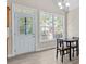 Bright dining area with a door to the deck, large windows, and hardwood floors at 2140 Wildcat Cliffs Way, Lawrenceville, GA 30043